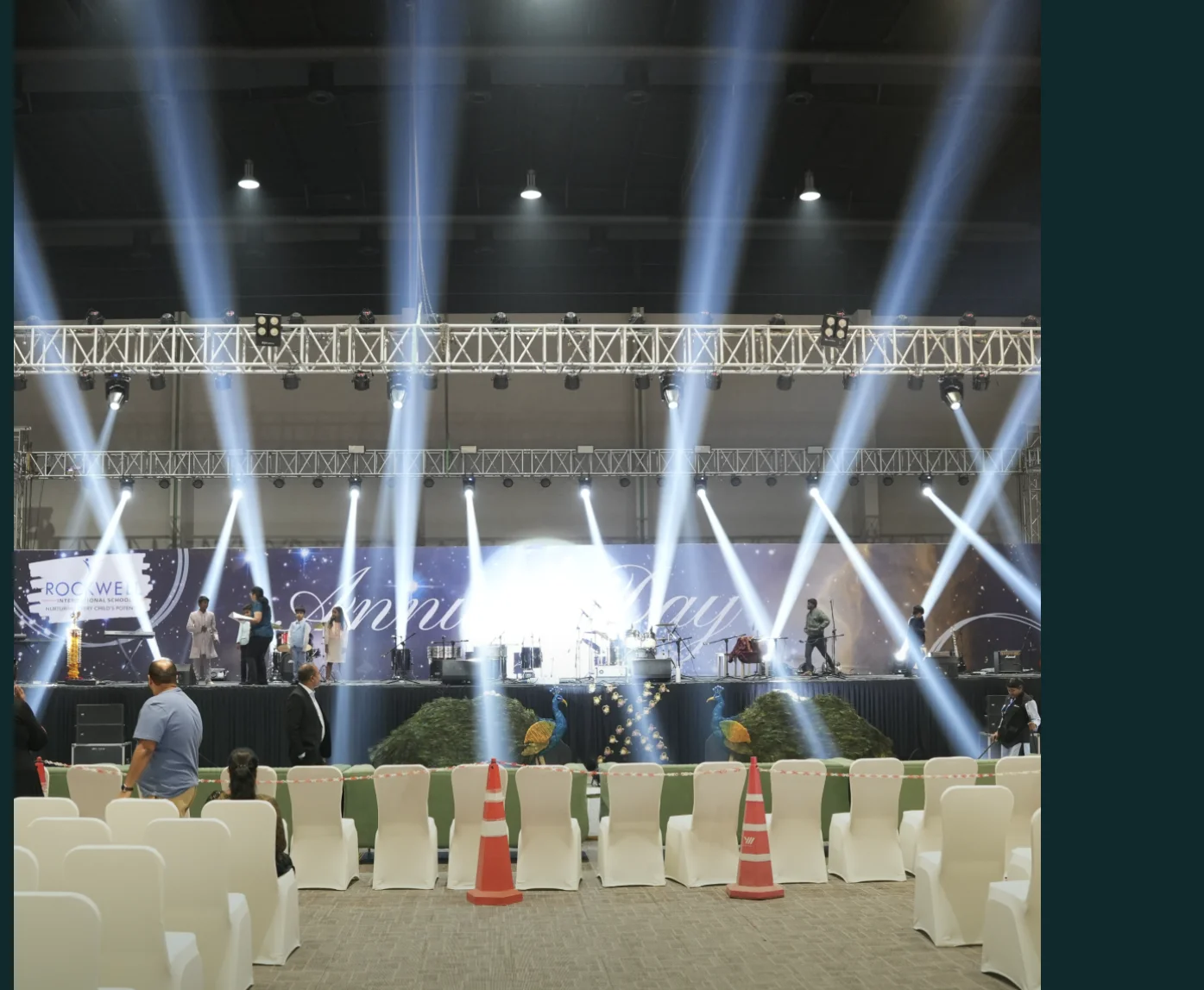 Corporate event setup inside Eventara with stage lighting and banquet seating
